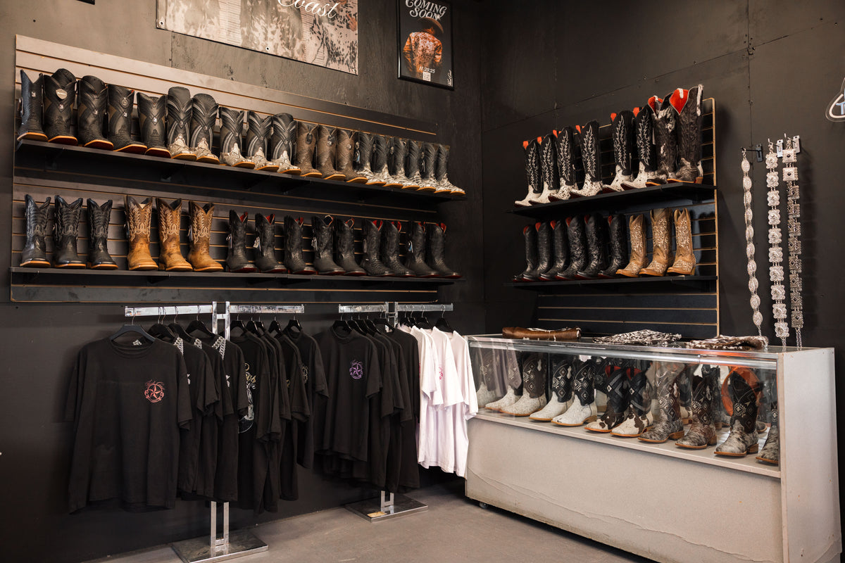 Inside the Third Coast booth at Traders Village: a wall of boots, tees on the rack and a glass case