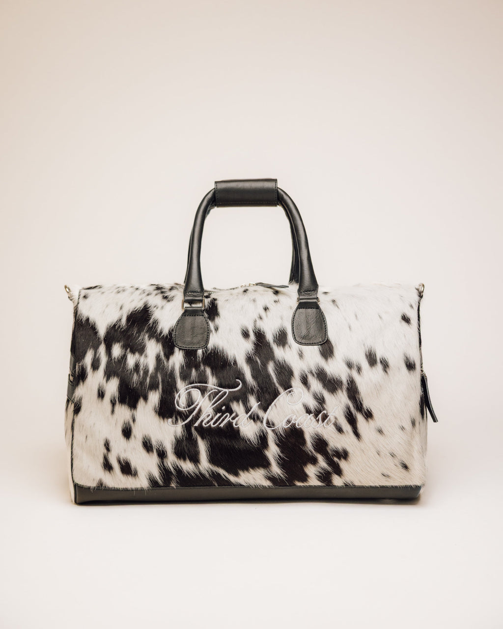 Black and white cowhide duffle bag with full-grain leather trim