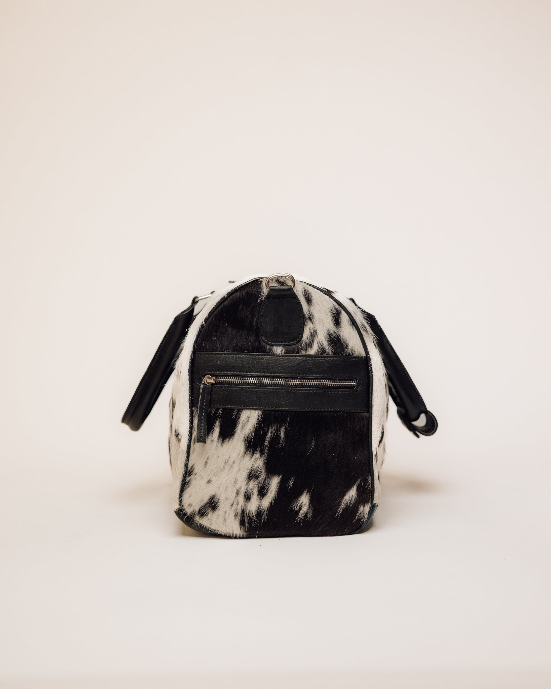 Black and white cowhide duffle, end panel and handle detail
