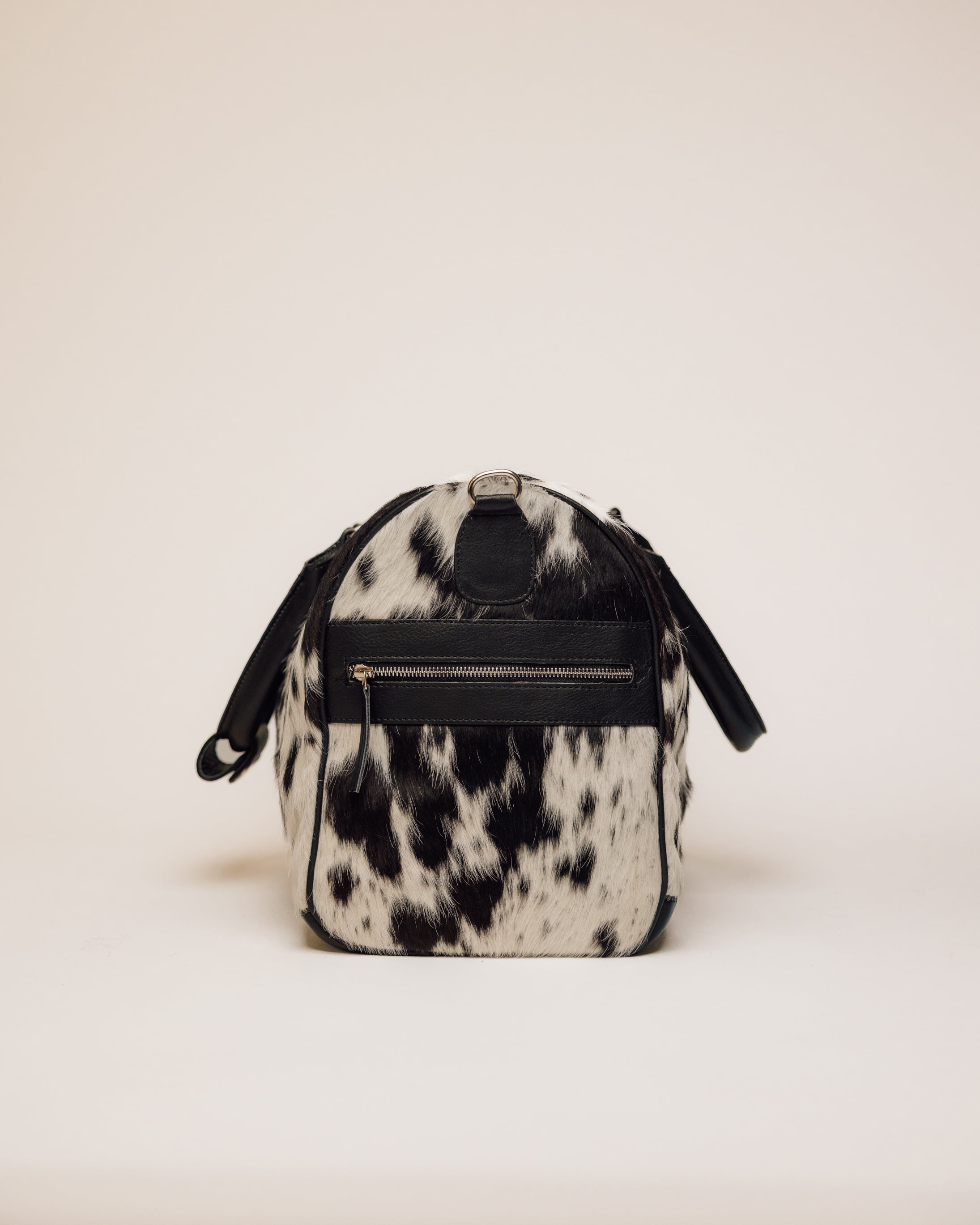 Cowhide duffle bag hardware and zipper detail, black and white