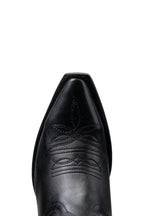 Close-up of snip toe and welt stitching on black leather cowgirl boot