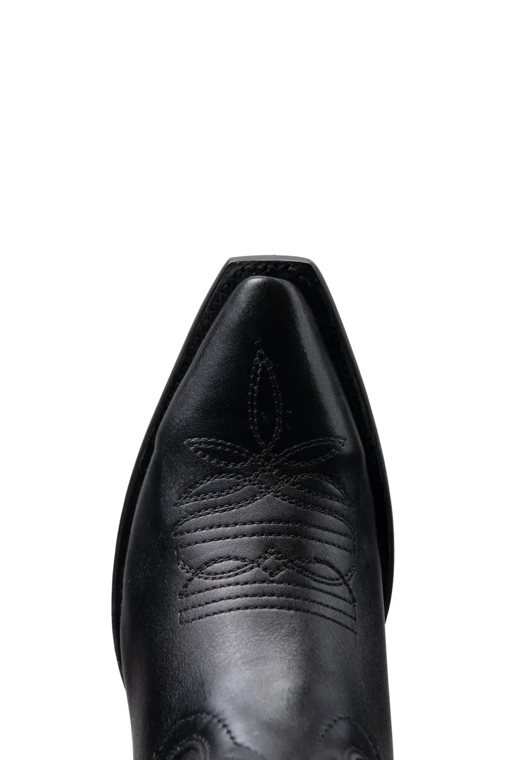 Close-up of snip toe and welt stitching on black leather cowgirl boot
