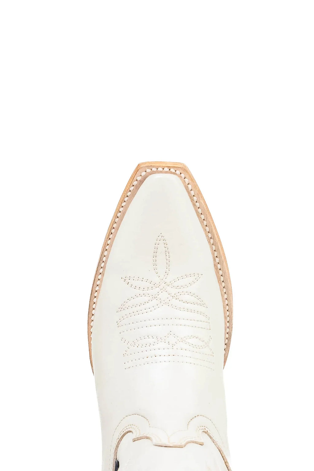 Close-up of snip toe and welt stitching on ivory leather cowgirl boot